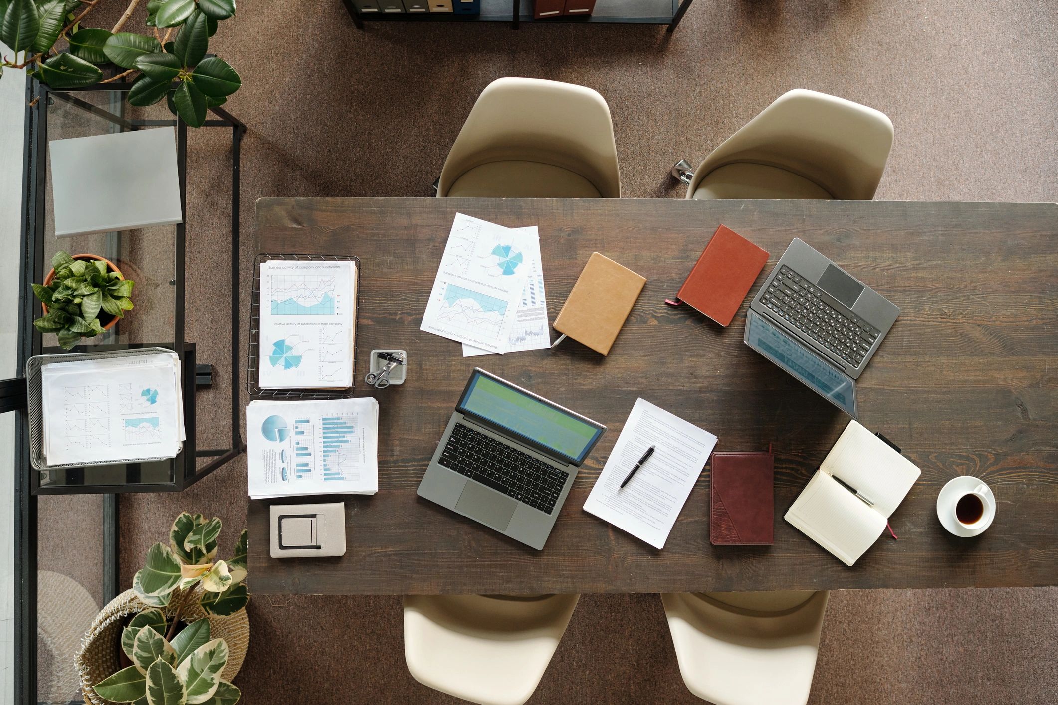 Office desk with laptops and financial documents arranged for a business meeting
